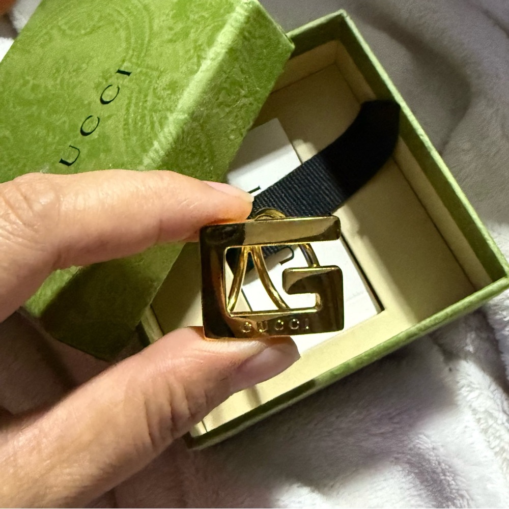 Gold metal Gucci scarf ring with logo at front